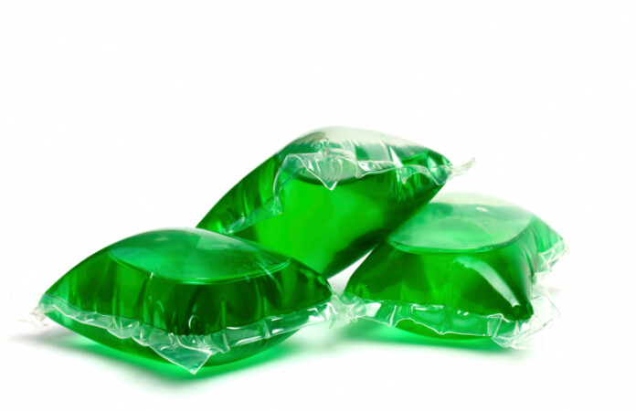 Three green laundry detergent capsules